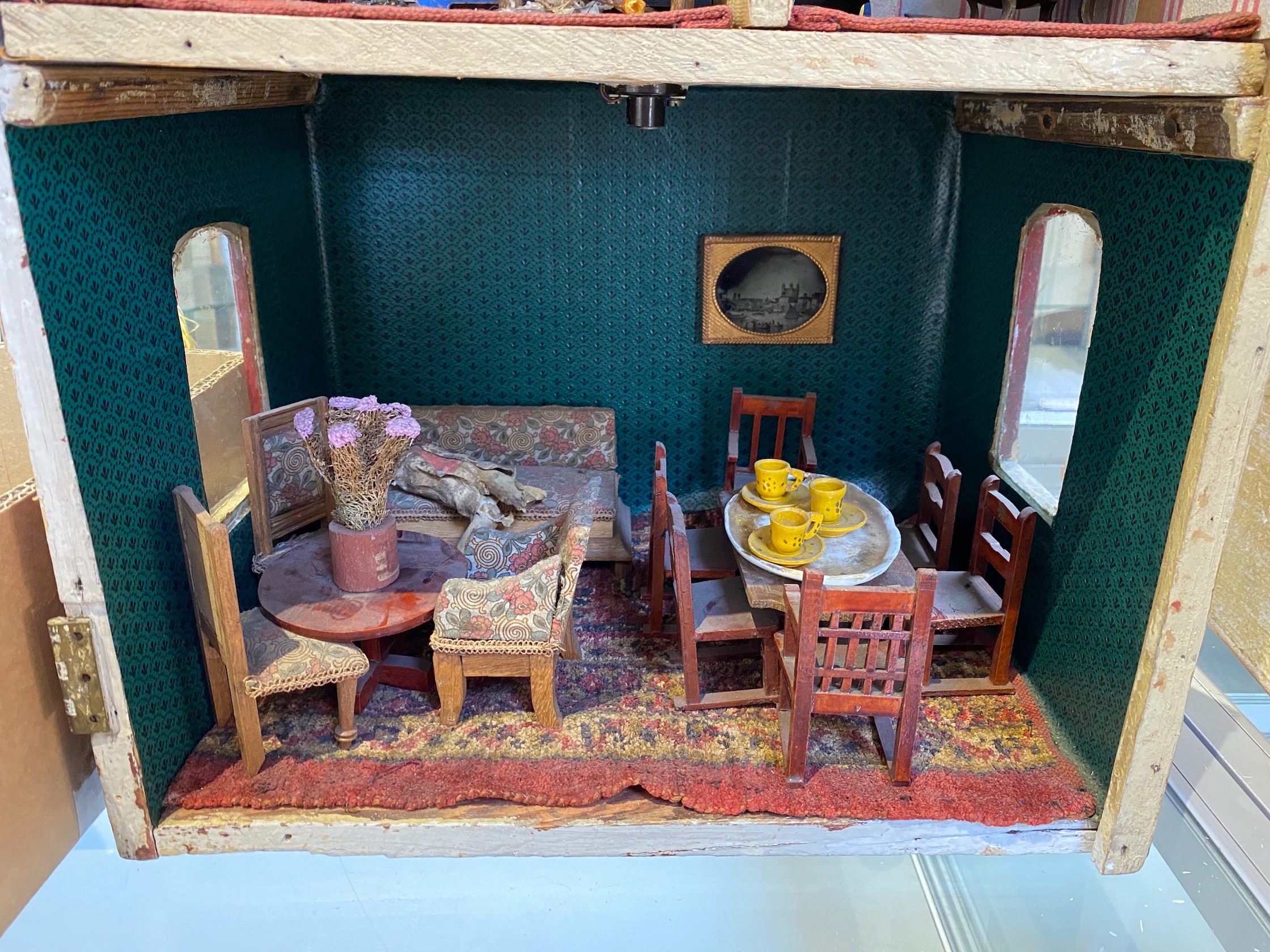 ‘Queens Lynn House’. A late 19th century home-made dolls' house, and contents, 66cm high